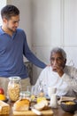 Portrait of happy granddad and grandson in cosy kitchen Royalty Free Stock Photo