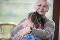 Portrait of happy grandmother hugging granddaughter in house Royalty Free Stock Photo