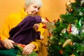 Portrait of happy grandmother hugging her granddaughter over Christmas presents and decorated New Year tree, merry Royalty Free Stock Photo