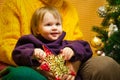 Portrait of happy grandmother hugging her granddaughter over Christmas presents and decorated New Year tree, merry Royalty Free Stock Photo