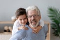 Portrait of happy grandson have fun piggyback smiling grandfather