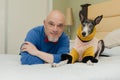 Portrait of a happy greyhound dog and its owner looking at the camera