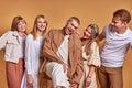 Portrait of happy group of caucasian youth having fun in studio