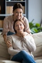 Portrait happy grownup daughter hugging pleasant mother.