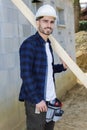 portrait happy and handsome carpenter holding plank Royalty Free Stock Photo