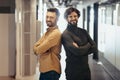 Portrait of happy handsome entrepreneurs posing with crossed arms and smiling in company hall. Business partnership Royalty Free Stock Photo