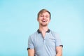 Portrait of happy handsome man laughing on blue background Royalty Free Stock Photo