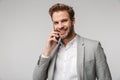 Portrait of happy handsome man talking on cellphone and smiling Royalty Free Stock Photo