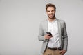 Portrait of happy handsome man typing on cellphone and smiling Royalty Free Stock Photo