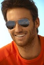 Portrait of happy handsome man wearing sunglasses