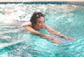 Happy and healthy Asian senior woman with kickboard in a swimming pool. Old woman wearingswimming in water with the help of a Royalty Free Stock Photo
