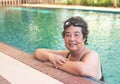 Happy and healthy Asian senior woman wearing swim goggles at swimming pool. Fit active senior woman enjoying retirement in Royalty Free Stock Photo