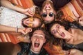 Portrait of happy hippies people laughing, and lying on blanket Royalty Free Stock Photo