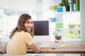 Portrait of happy hipster working at computer desk