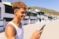 Portrait of a happy hispanic latin man using mobile phone on the beach Royalty Free Stock Photo