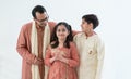 Portrait of happy Indian family handsome teenage son, little daughter and father embracing standing and talking, wearing Royalty Free Stock Photo