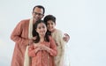 Portrait of happy Indian family handsome teenage son, little daughter and father embracing standing, wearing traditional clothing Royalty Free Stock Photo