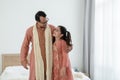 Portrait of happy Indian family standing and hugging in bedroom at home. Smart young father with little cute daughter Royalty Free Stock Photo