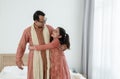 Portrait of happy Indian family standing and hugging in bedroom at home. Smart young father with little cute daughter Royalty Free Stock Photo