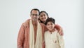 Portrait of happy Indian family standing over white background. Smart young father with little cute kids wear traditional dress, Royalty Free Stock Photo