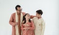 Portrait of happy Indian family standing over white background. Smart young father with little cute kids wearing traditional dress Royalty Free Stock Photo