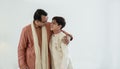 Portrait of happy Indian family standing over white background. Smart young father with little handsome son wear traditional dress Royalty Free Stock Photo