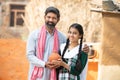 Portrait Of Happy Indian Farmer Father And Daughter Holding Clay Money Box Or Gullak, Smiling Beard Man And Young Girl Traditional