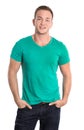 Portrait: Happy isolated young man wearing green shirt and jeans Royalty Free Stock Photo