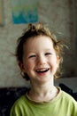 Portrait of happy joyful beautiful little boy with light hair, great hairstyle. He laughs and smiles Royalty Free Stock Photo