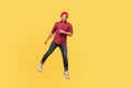 Portrait happy joyful hipster trendy guy levitating, looking at camera with toothy smile, hovering in mid-air, doing step