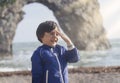 Portrait of happy kid boy smiling standing by the sea with blurry background, Chid playing in the Durdle Door beach in the weekend