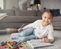 Portrait of happy kid, girl and pencils for coloring on living room floor for education, learning and creative Royalty Free Stock Photo