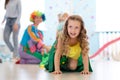 Portrait of happy kid scrambling in tunnel during birthday party Royalty Free Stock Photo