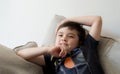 Portrait happy kid laughing, Cute little boy with big smile sitting on soafa having fun watching cartoon on TV, Positive child Royalty Free Stock Photo