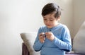 Portrait happy kid playing alone in living room, New normal life stlye Child relaxing at home on weekend. cute boy looking at Royalty Free Stock Photo
