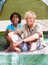 Portrait, happy kids and friends camping in tent together, bonding and relax outdoor on summer holiday. Young boys Royalty Free Stock Photo