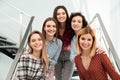 Portrait of happy ladies on stairs. Women power concept