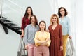 Portrait of happy ladies on stairs. Women power concept