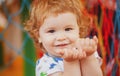 Portrait of a happy laughing baby child on playground. Close up positive kids face. Royalty Free Stock Photo