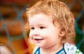 Portrait of a happy laughing baby child on sunny day. Close up positive kids on playground. Smiling infant, cute smile. Royalty Free Stock Photo