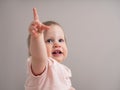 Portrait of a happy laughing baby, with a funny expression on his face. A little beautiful girl with blue eyes smiles cheerfully Royalty Free Stock Photo