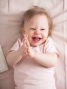 Portrait of a happy laughing baby, with a funny expression on his face. A small beautiful girl with blue eyes smiles cheerfully, Royalty Free Stock Photo