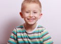 Portrait of happy laughing blond boy child kid at the table Royalty Free Stock Photo