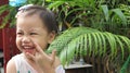 Portrait of happy laughing charming 3 years old Asian little girl smiling happily outdoors Royalty Free Stock Photo