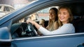 Portrait of happy laughing girls having fun while driving a car in city Royalty Free Stock Photo