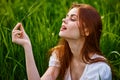 portrait of a happy, laughing woman sitting in tall grass in a field Royalty Free Stock Photo