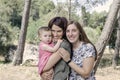 Portrait of happy lesbians mothers with a baby. Homosexual fami Royalty Free Stock Photo