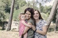 Portrait of happy lesbians mothers with a baby. Homosexual fami