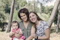 Portrait of happy lesbians mothers with a baby. Homosexual fami Royalty Free Stock Photo