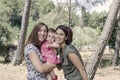 Portrait of happy lesbians mothers with a baby. Homosexual fami Royalty Free Stock Photo